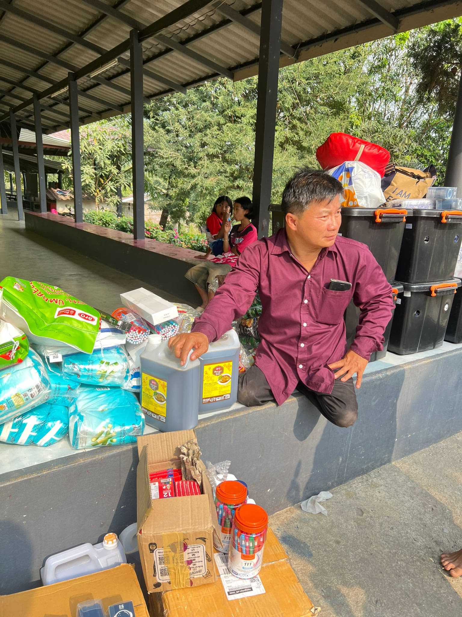 Bilay sitting with supplies