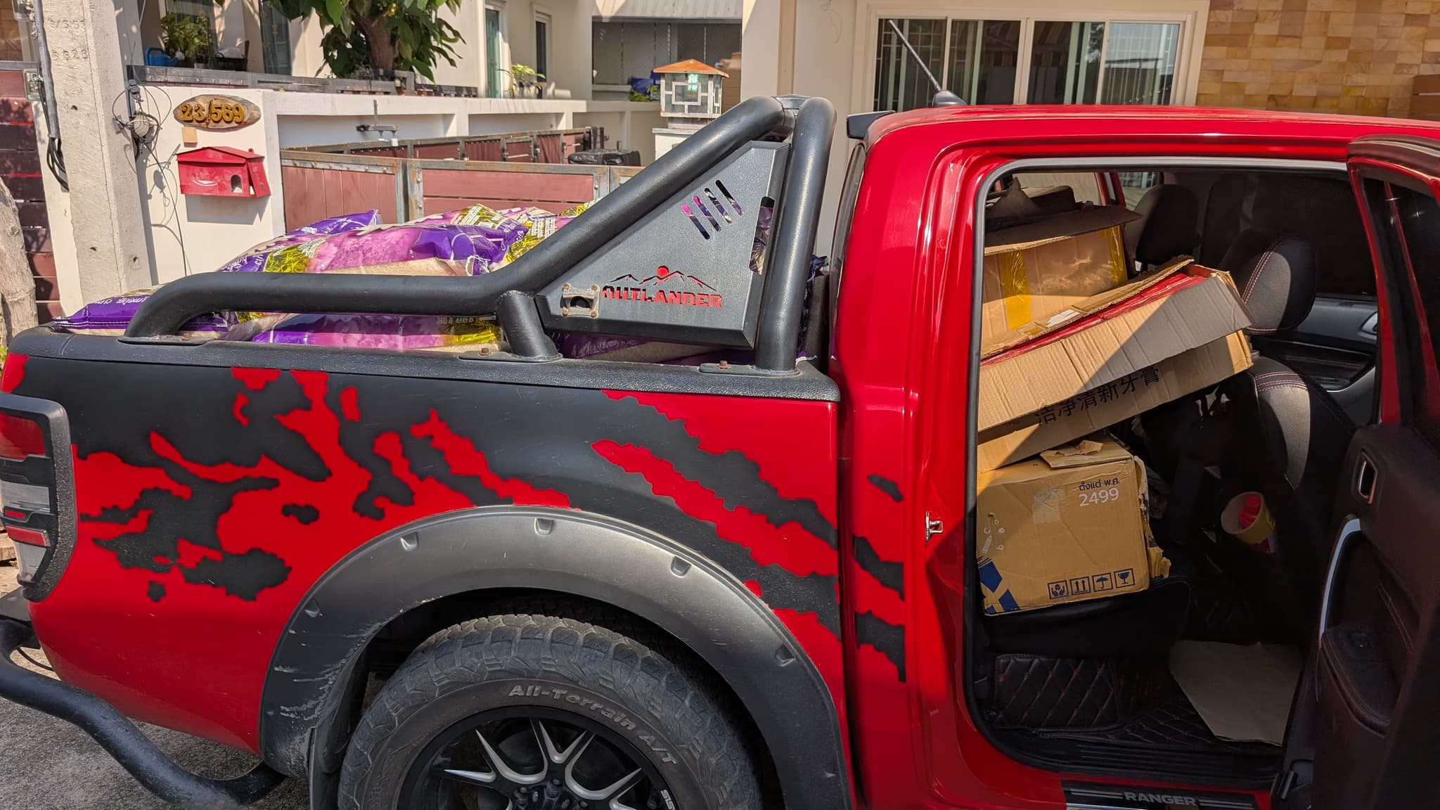 Pre-dawn loading: rice in the bed, Lazada boxes in the back seat. — January 2026 · 80 children fed